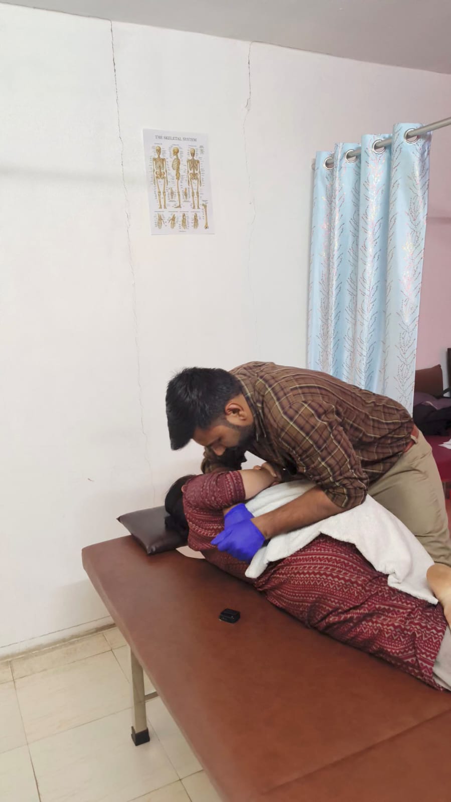 Patient consultation and assessment at Spine-X Chiropractic clinic