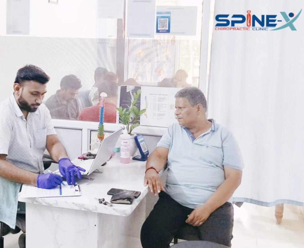Patient receiving customized treatment plan at Spine-X Chiropractic